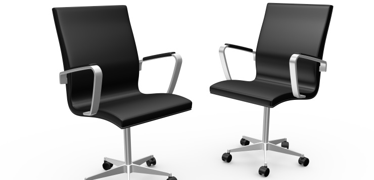 Two black leather boss chairs for office, isolated on white background.