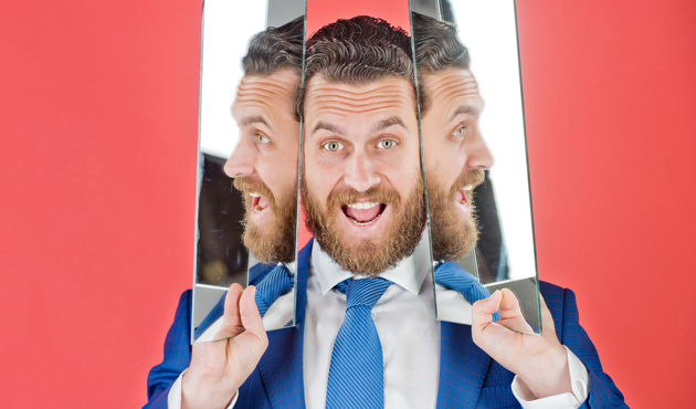happy face of bearded hipster man, businessman reflecting in mirror