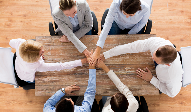 close up of business team with hands on top