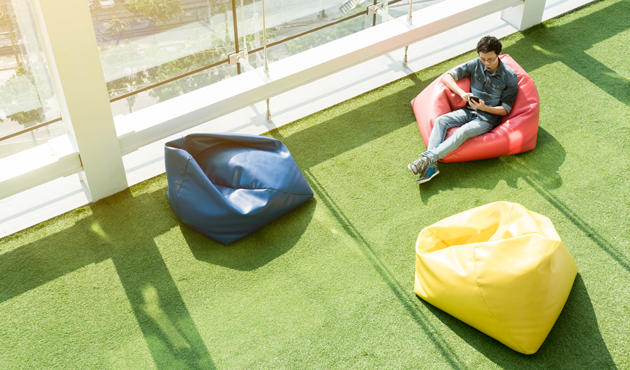 Man use smartphone on bean bag in afternoon, freelance conceptua